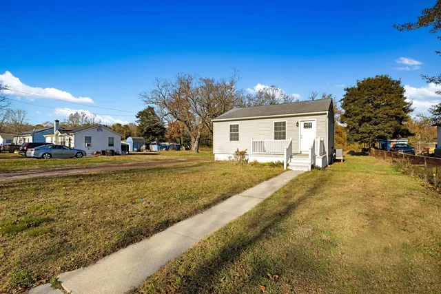 a view of an ocean with a house in the background