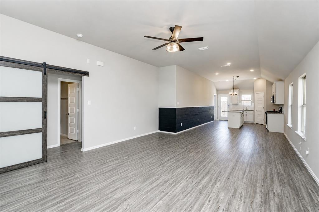 3344 Duncan Way Corinth, TX 76210 - Photo 3 of 38 Open-concept living area with wood-finish flooring