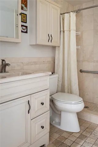 a bathroom with a toilet sink and vanity