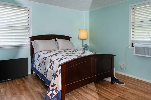 a bedroom with a bed and a lamp on the dresser