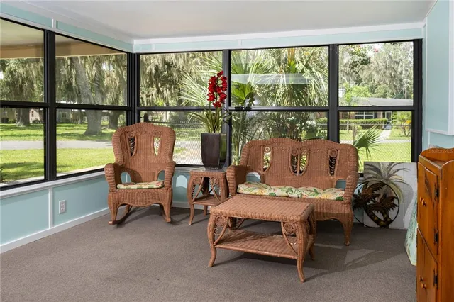 a living room with furniture and a floor to ceiling window