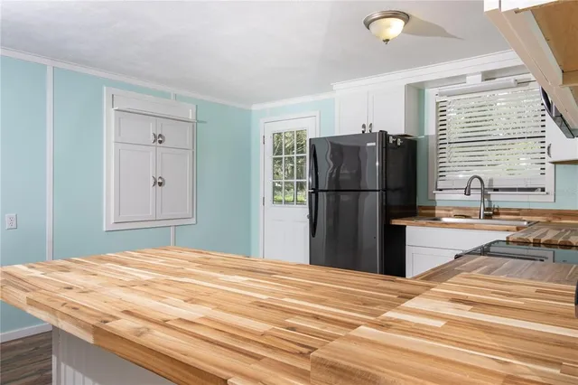 a kitchen with stainless steel appliances granite countertop a refrigerator and a stove top oven