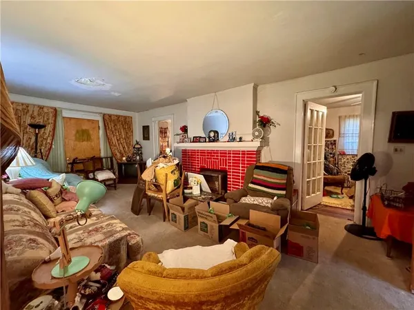 a living room with furniture and a chandelier