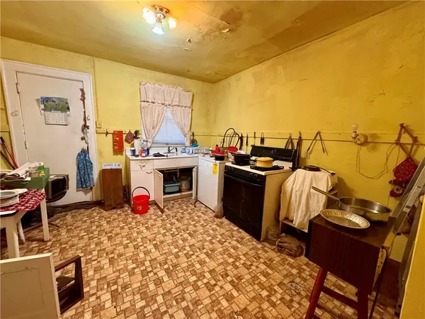 a view of a kitchen with fridge and stove