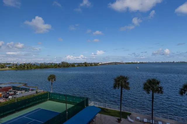 a view of a lake with couches in front of house