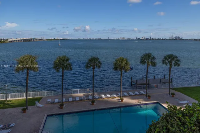 a view of a lake with a table and chairs