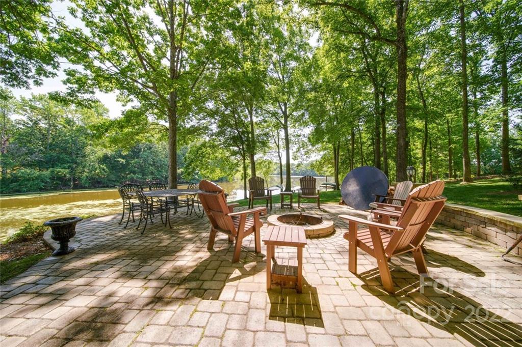 3617 Lake Twitty Drive Monroe, NC 28110 - Photo 15 of 47 a view of a patio with table and chairs and potted plants with large tree