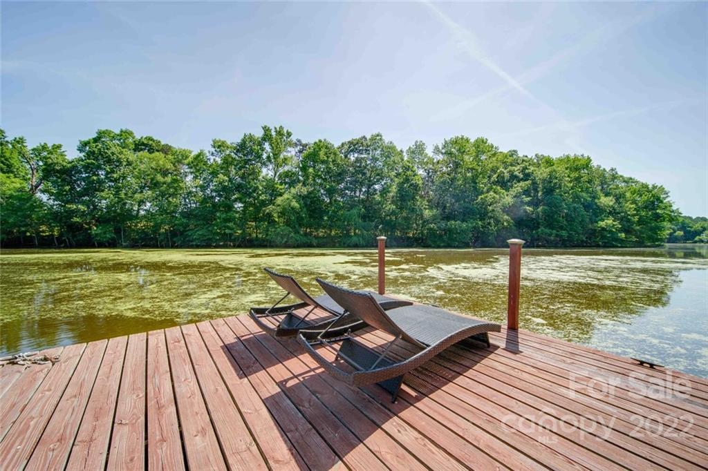 3617 Lake Twitty Drive Monroe, NC 28110 - Photo 16 of 47 a view of a balcony with wooden floor and lake view