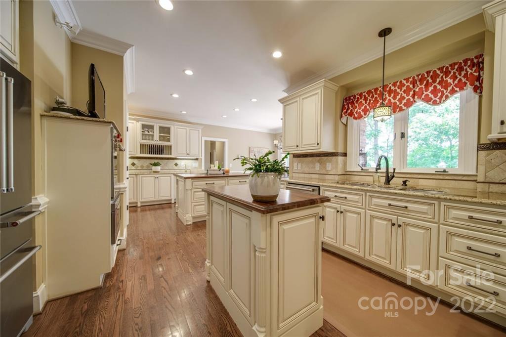 3617 Lake Twitty Drive Monroe, NC 28110 - Photo 23 of 47 a kitchen with kitchen island granite countertop a sink appliances cabinets and a counter top space