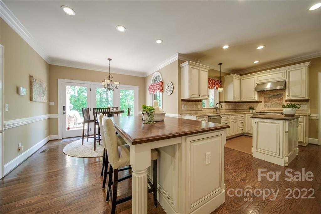 3617 Lake Twitty Drive Monroe, NC 28110 - Photo 24 of 47 a kitchen with stainless steel appliances granite countertop a table chairs sink and cabinets