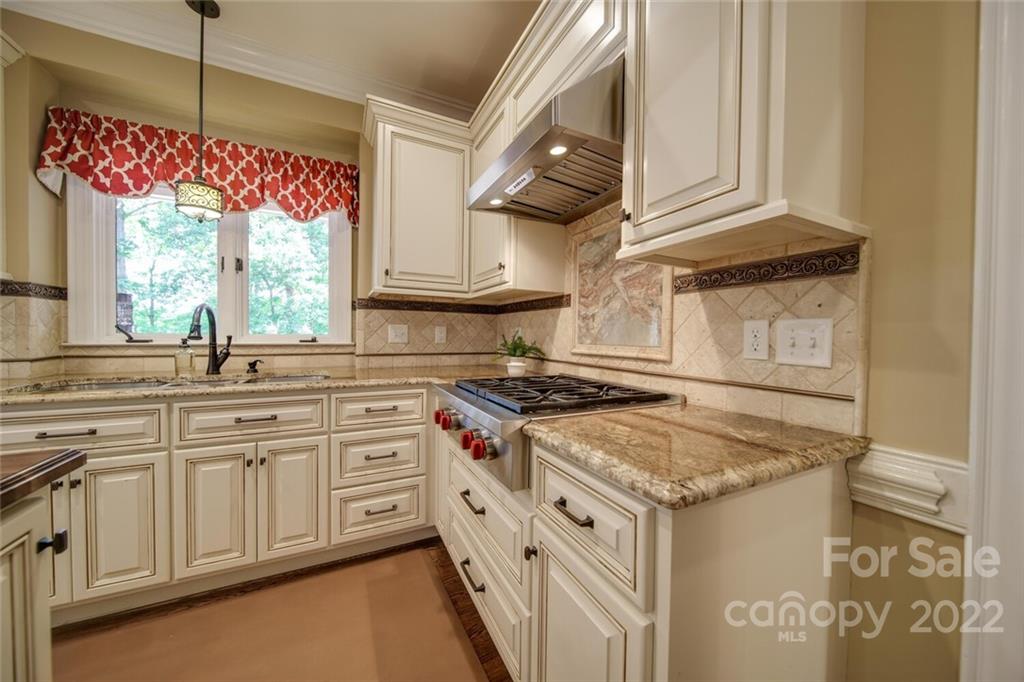 3617 Lake Twitty Drive Monroe, NC 28110 - Photo 27 of 47 a kitchen with granite countertop a sink stove and cabinets