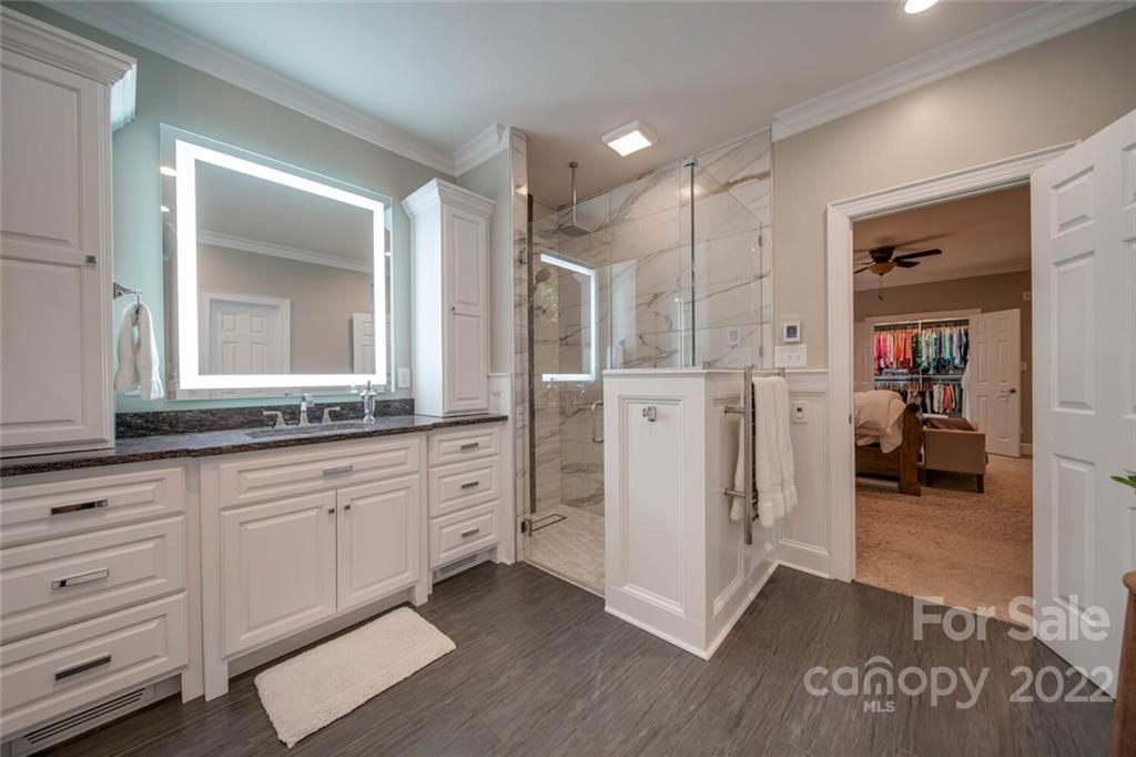 3617 Lake Twitty Drive Monroe, NC 28110 - Photo 35 of 47 a spacious bathroom with a granite countertop sink and a mirror
