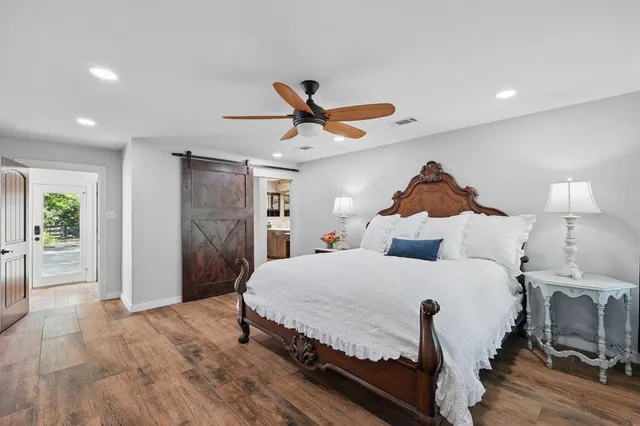 a bedroom with a bed and a ceiling fan