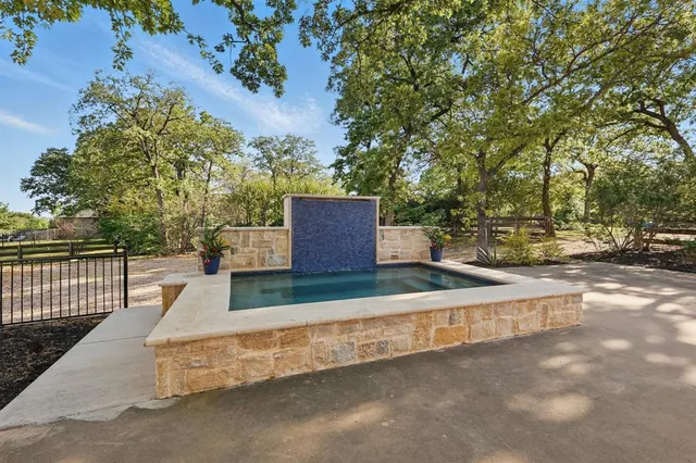 a view of a patio with couches and table and chairs with wooden fence