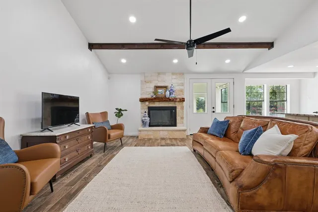 a living room with furniture flat screen tv and a fireplace