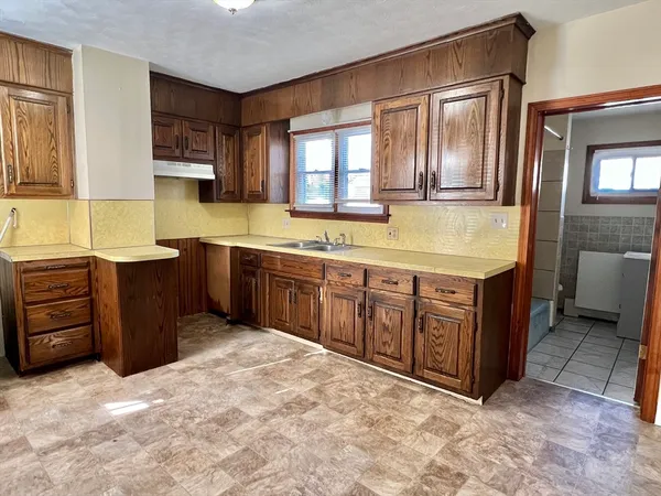 a spacious bathroom with a granite countertop double vanity and a mirror
