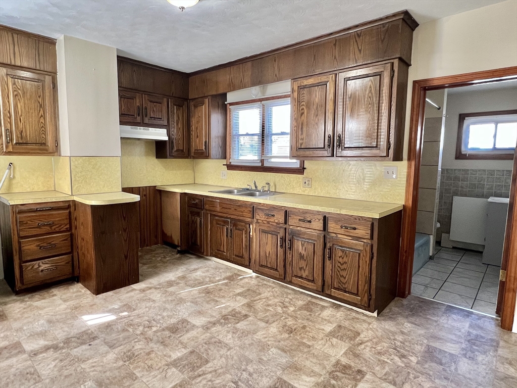 315 Main Street, Unit 1 Springfield, MA 01151 - Photo 2 of 10 a spacious bathroom with a granite countertop double vanity and a mirror