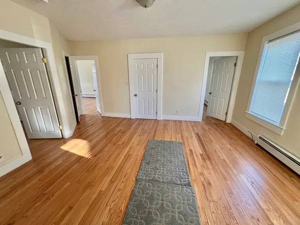 a view of a room with wooden floor and staircase