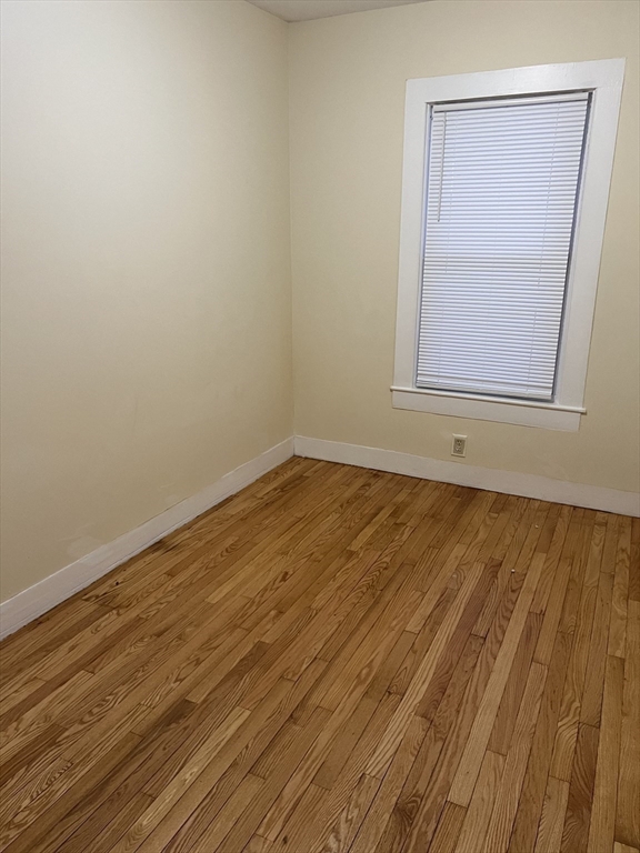 315 Main Street, Unit 1 Springfield, MA 01151 - Photo 7 of 10 a view of empty room with wooden floor and fan
