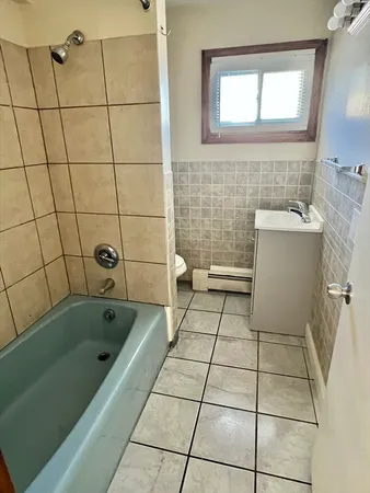 a bathroom with a bathtub and a shower