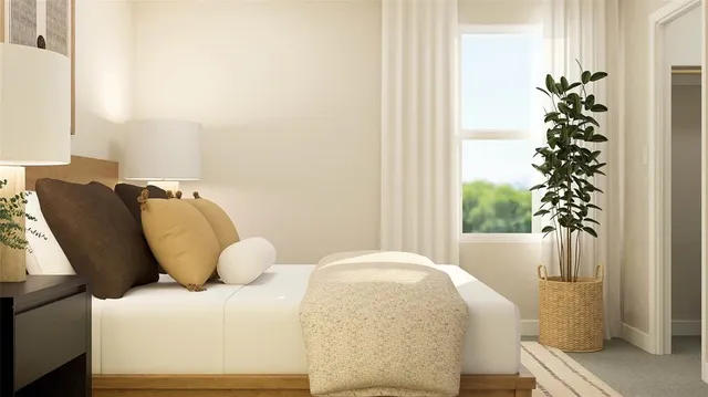 a bed sitting in a bedroom next to a window