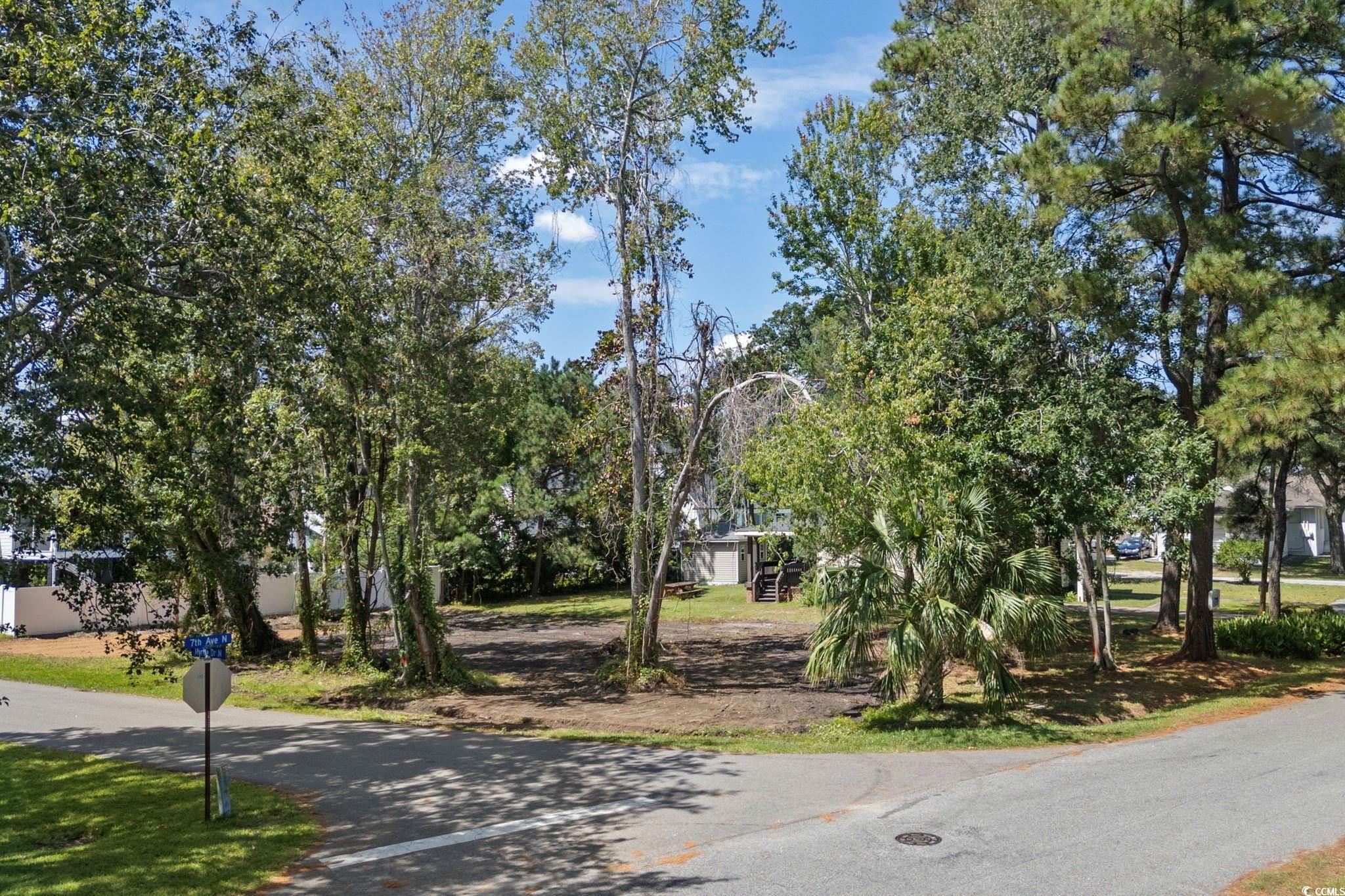 511 7th Avenue North Surfside Beach, SC 29575 - Photo 2 of 24 View of asphalt road with traffic signs