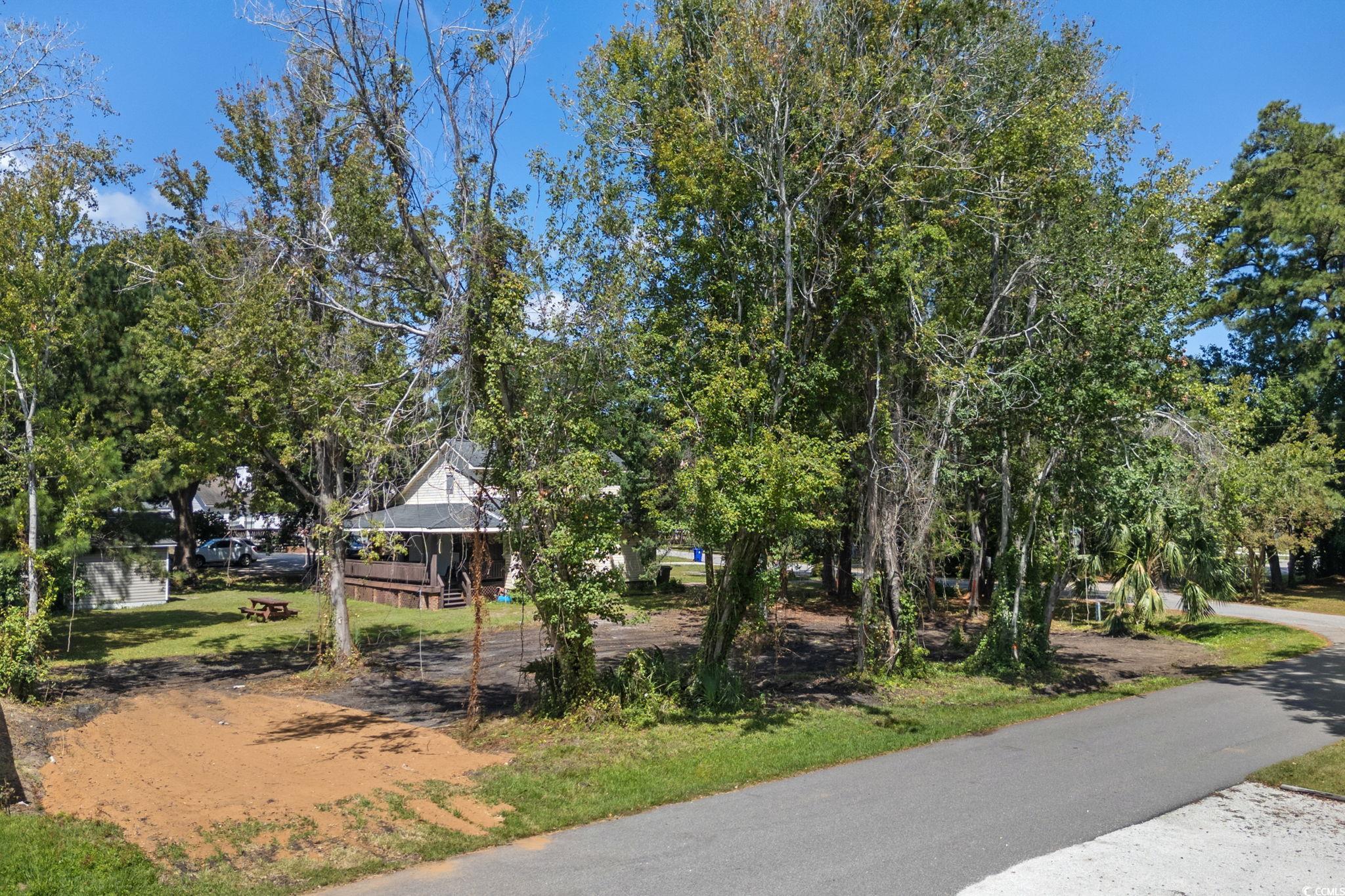 511 7th Avenue North Surfside Beach, SC 29575 - Photo 3 of 24 View of home's community featuring view of wooded