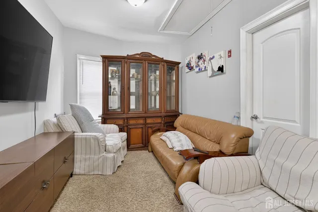 a living room with furniture fireplace and a flat screen tv