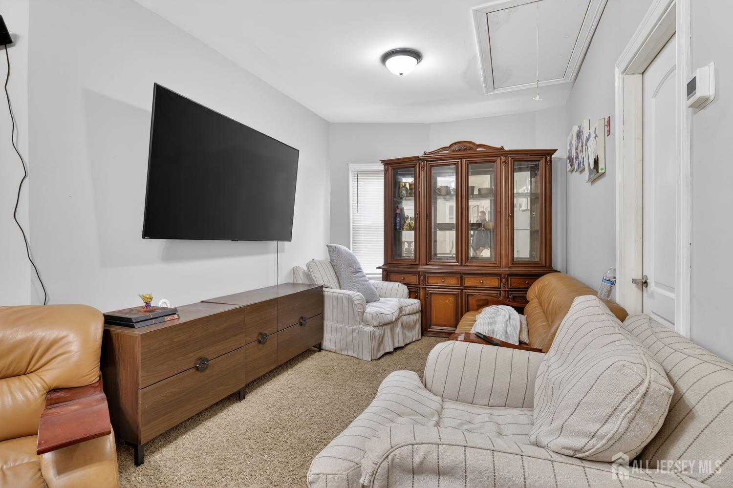 441 South Clinton Street East Orange, NJ 07018 - Photo 17 of 27 a living room with furniture and a flat screen tv