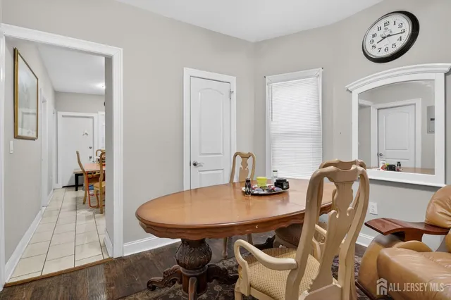 a view of a room that has a table and a chair in it