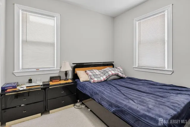 a bed room with furniture and window