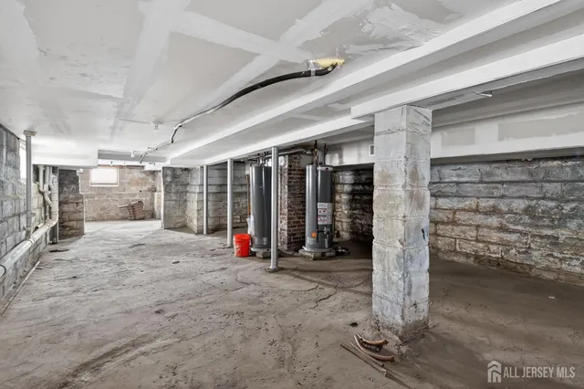 a view of a hall with floor to ceiling windows and yard