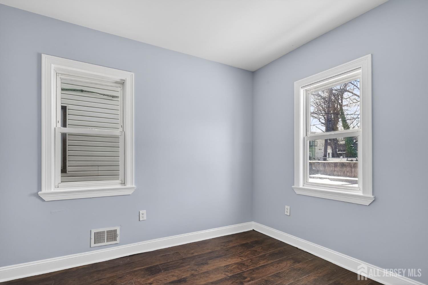 441 South Clinton Street East Orange, NJ 07018 - Photo 10 of 27 a view of an empty room with wooden floor and a window