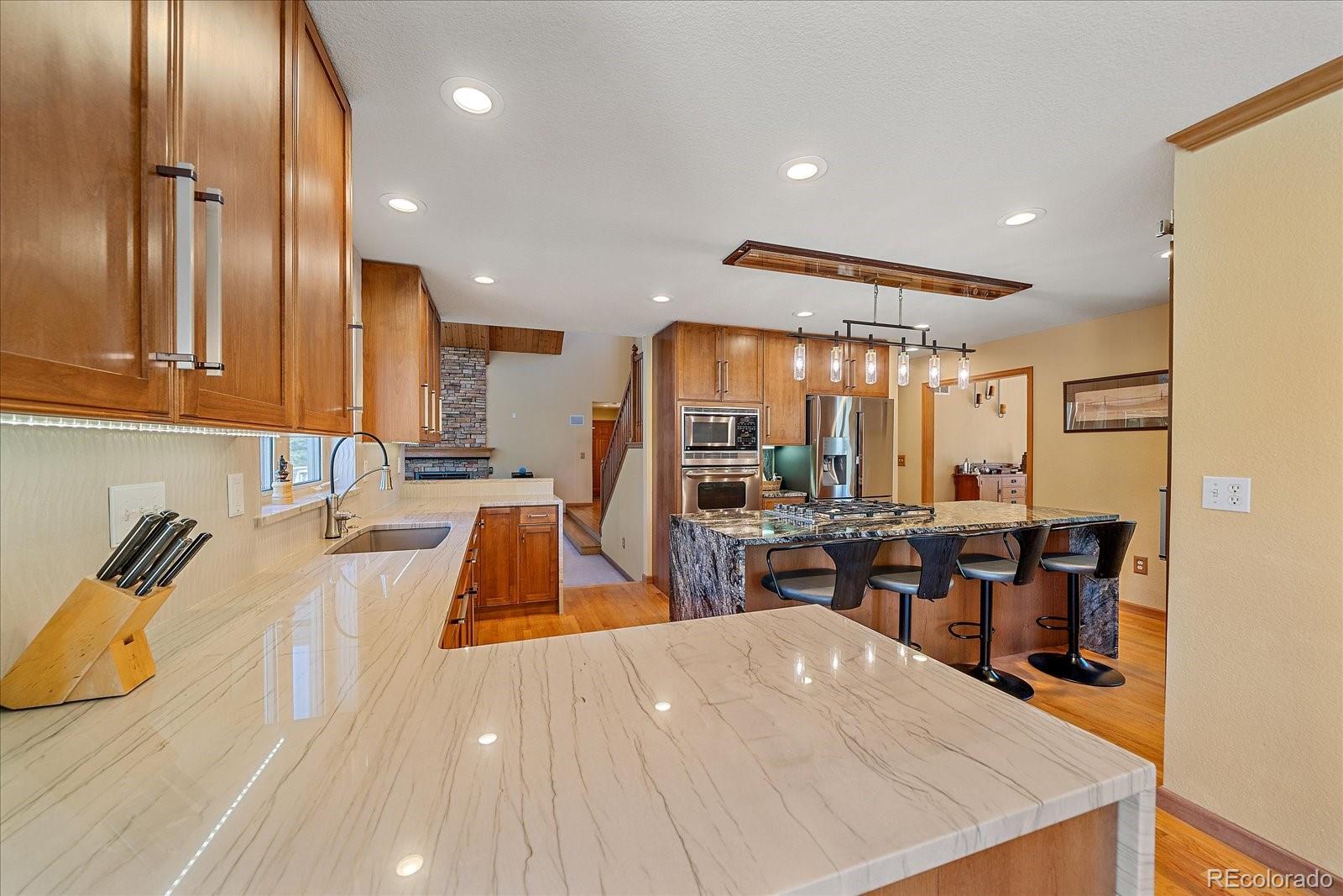 9948 South Turkey Creek Road Conifer, CO 80433 - Photo 15 of 50 a large kitchen with lots of counter space and windows