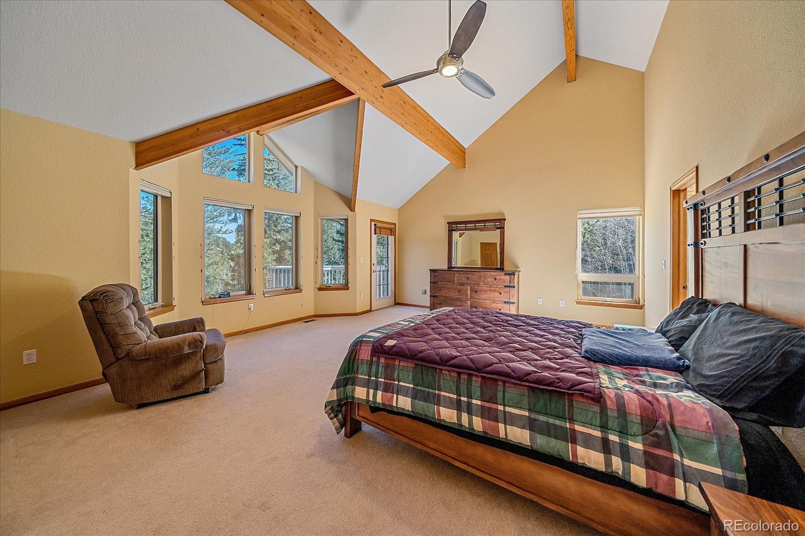 9948 South Turkey Creek Road Conifer, CO 80433 - Photo 26 of 50 a bedroom with a bed and a couch