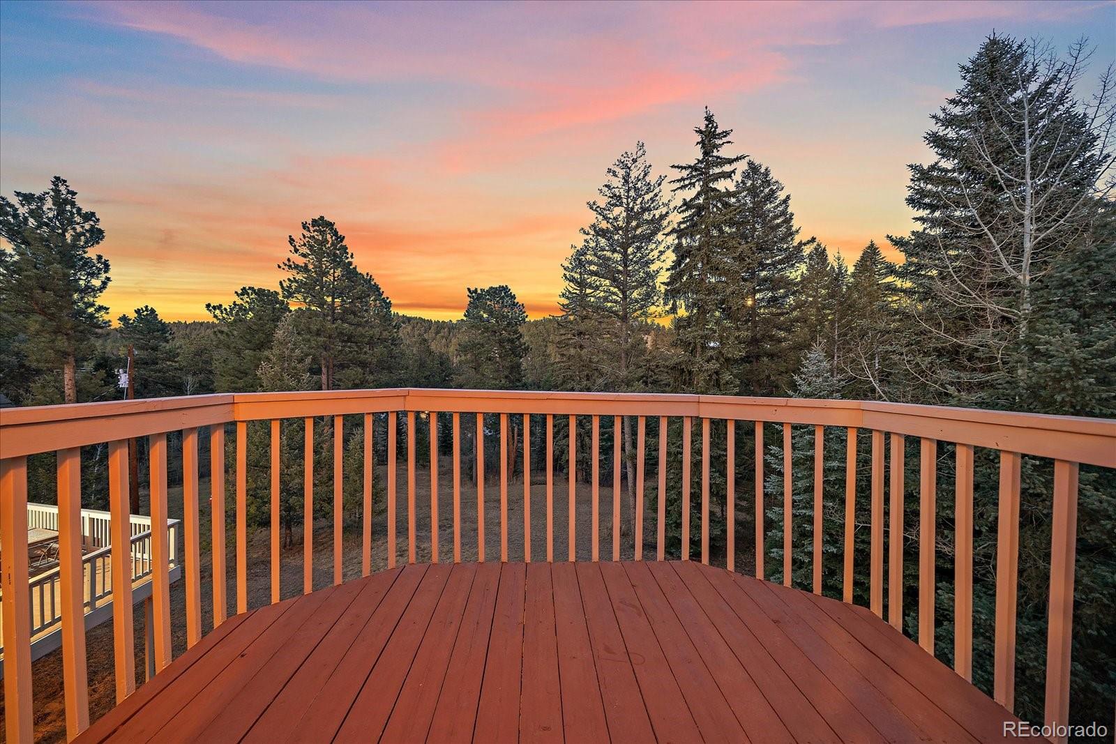9948 South Turkey Creek Road Conifer, CO 80433 - Photo 30 of 50 a balcony with wooden floor and fence