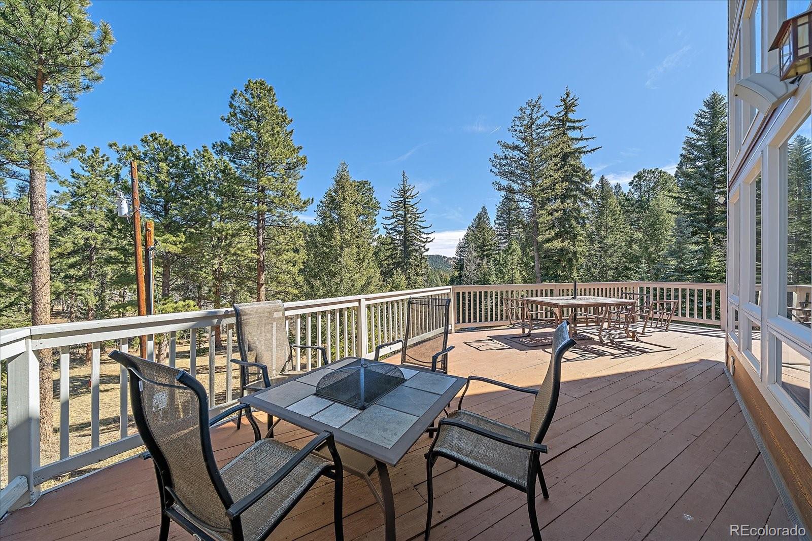 9948 South Turkey Creek Road Conifer, CO 80433 - Photo 46 of 50 a view of a chairs and table on the deck