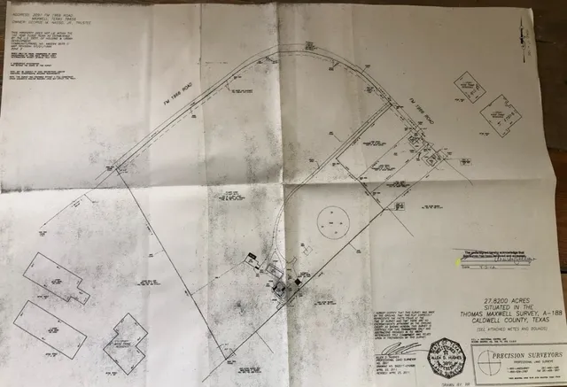 a view of a lake with beach and large trees