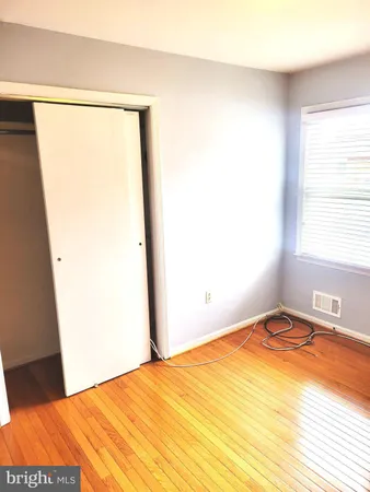 a view of a room with wooden floor and window