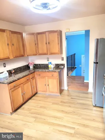 a kitchen with stainless steel appliances granite countertop a sink and a stove