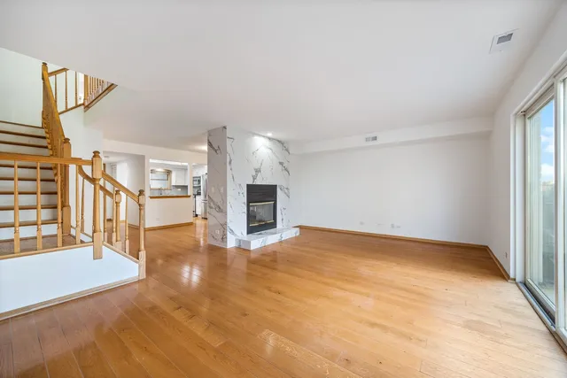 a view of an empty room with a fireplace and a window