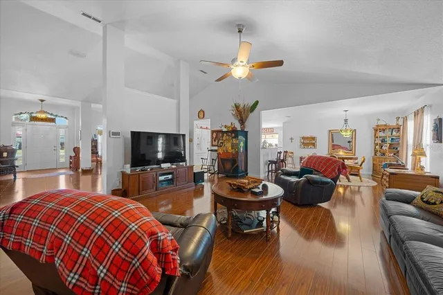 a dining room with furniture and wooden floor