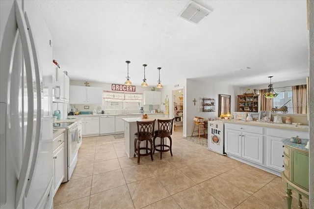 a kitchen with white cabinets and white appliances