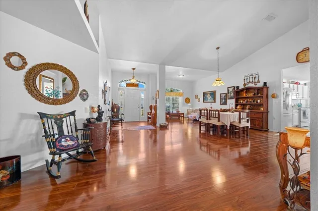 a living room with furniture dining table and a large window