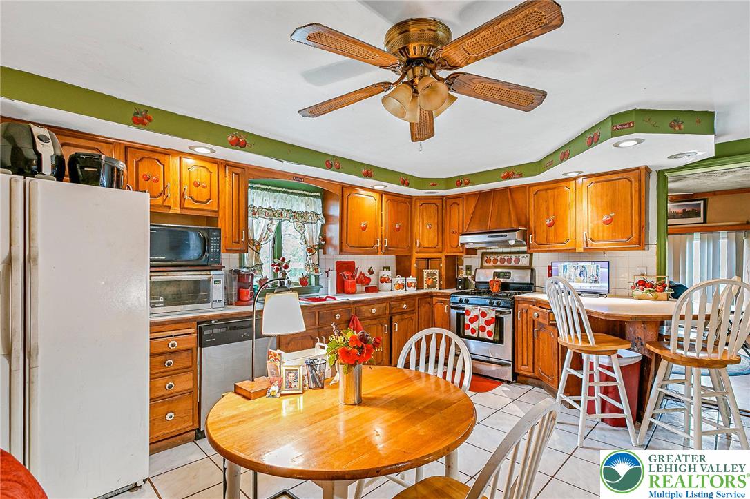 174 North Chestnut Street Bath, PA 18014 - Photo 8 of 20 a view of a dining room with furniture a chandelier and a large window