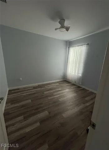a view of room with window and hardwood floor