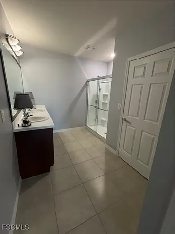 a bathroom with a sink vanity and mirror