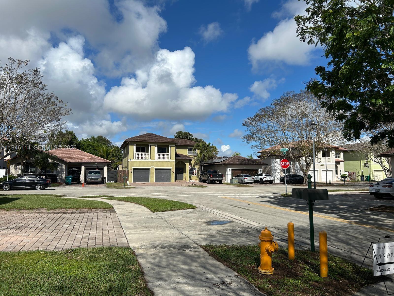 22844 Southwest 114th Avenue Miami, FL 33170 - Photo 12 of 40 a front view of a building with lot of cars and trees