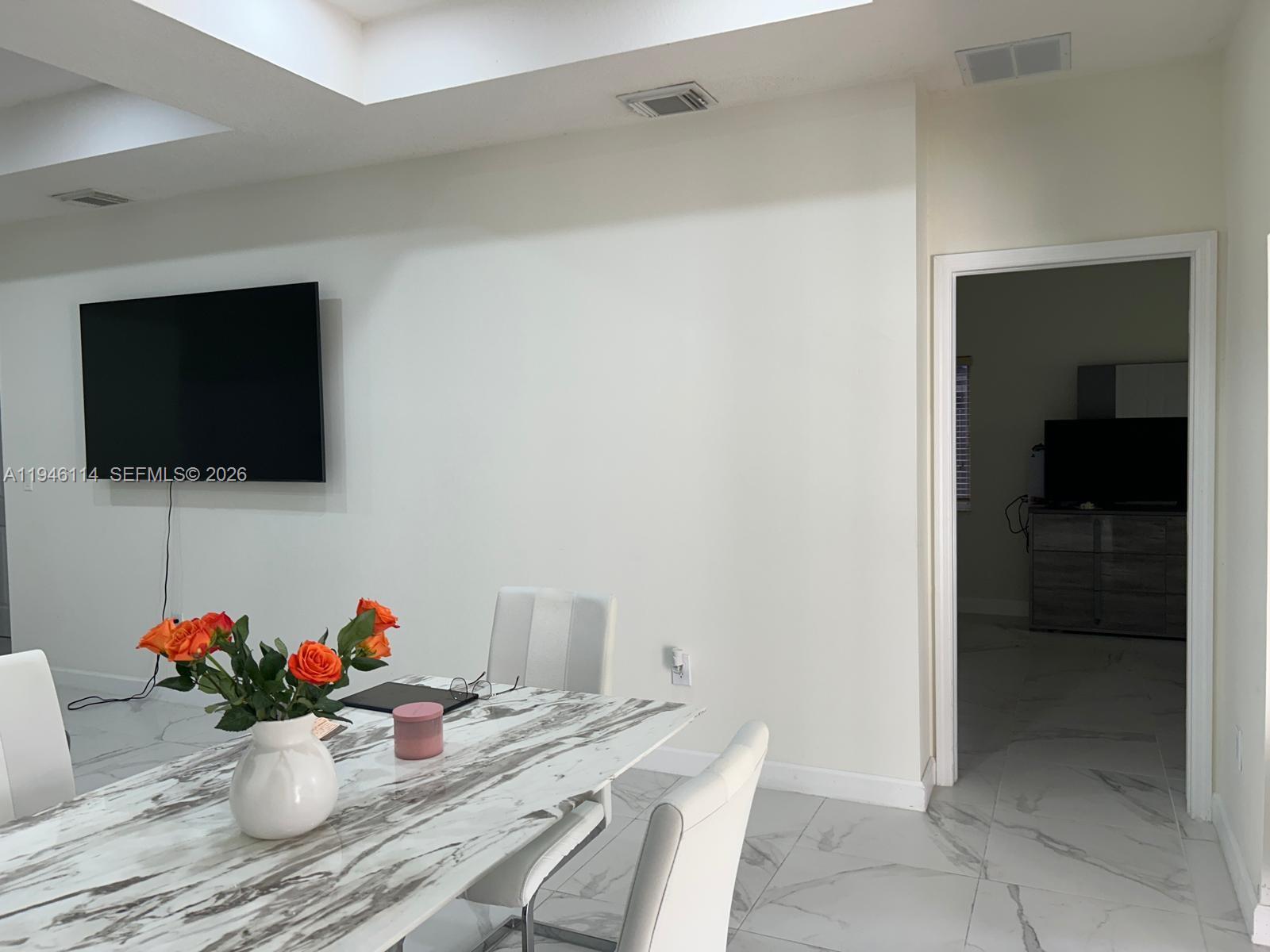 22844 Southwest 114th Avenue Miami, FL 33170 - Photo 15 of 40 a living room with furniture and a flat screen tv
