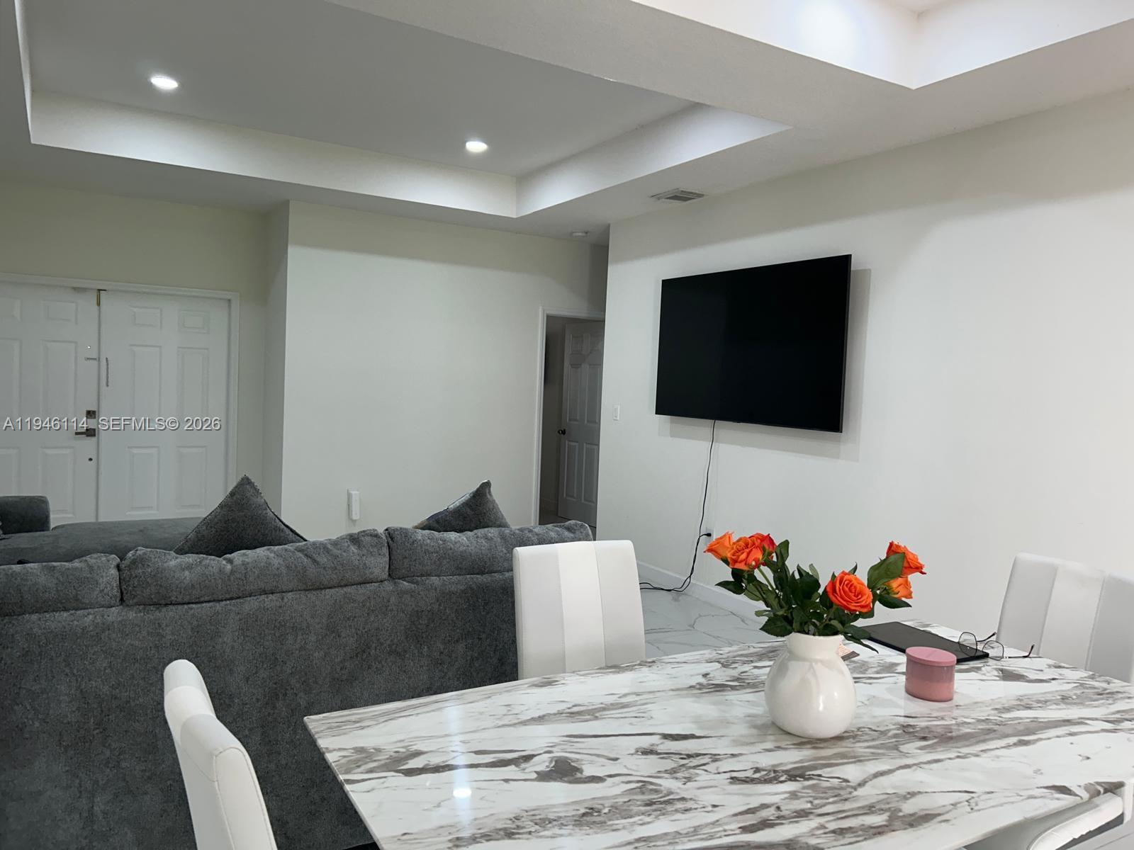 22844 Southwest 114th Avenue Miami, FL 33170 - Photo 16 of 40 a living room with furniture and a flat screen tv